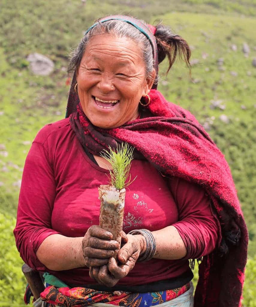 Planting Trees & Nepal Nurseries - Meet Shushila & Kanchi. Kanchi smiles while she works in the tree planting nursery